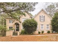 Charming two-story home with landscaped yard and stone accents on entry at 3839 Mountain Cove Dr, Charlotte, NC 28216