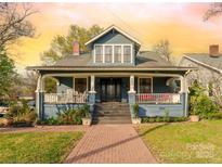 Charming two-story home featuring a welcoming front porch, brick walkway, and well-manicured landscaping at 430 Maupin Ave, Salisbury, NC 28144