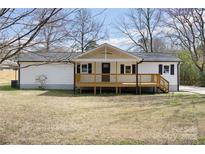 Charming single-story home featuring a covered front porch and well-maintained white siding at 5015 Forestmont Dr, Matthews, NC 28105