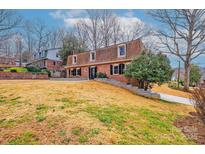 Charming brick home with dormer windows and mature landscaping on a sunny day at 651 25Th Nw Ave, Hickory, NC 28601