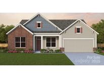 Charming one-story home with a brick accent, covered porch, and a two-car garage at 7153 Chamberlain Dr, Harrisburg, NC 28075