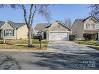 Charming single-Gathering home features a spacious driveway and inviting front yard with mature tree at 8545 Filbert Ln, Charlotte, NC 28215