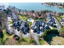 Stunning aerial view of lakefront townhomes with a community pool and mature landscaping at 101 N Cove Key Ln, Mooresville, NC 28117