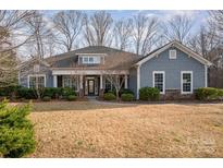 Charming single Gathering home featuring a cozy front porch and beautiful stone accents at 1061 Verbena Ct, Tega Cay, SC 29708