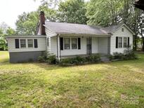 Charming single-story home with a classic white facade, black shutters, and a welcoming front porch at 3672 Nc Hwy 127 Hwy, Hickory, NC 28602