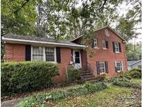 Charming two-story brick home featuring a landscaped yard and welcoming front entrance at 5635 Ruth Dr, Charlotte, NC 28215