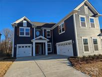 Charming two-story home with a two-car garage, driveway and traditional architectural details at 8231 Annsborough Nw Dr, Concord, NC 28027