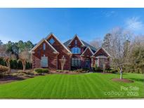 Inviting two-story brick home with manicured lawn and tasteful landscaping at 1038 Rolling Park Ln, Fort Mill, SC 29715