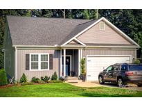 Charming single-story home with manicured lawn, attached garage and inviting front entrance at 1123 Fieldstone Rd # 9B, Mooresville, NC 28115