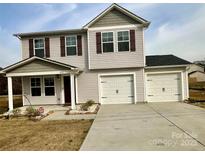 Charming two-story home featuring a two-car garage and a well-maintained front yard at 1431 Springdale Rd, Lancaster, SC 29720