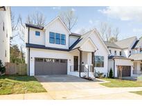Charming two-story home featuring a modern farmhouse design, neutral colors and inviting curb appeal at 2013 South St, Charlotte, NC 28208