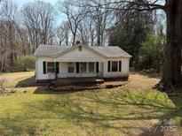 Charming single-story home featuring a cozy front porch and traditional design at 208 River Loop Rd, Belmont, NC 28012