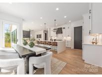 Open-concept design connects the dining area, kitchen, and living room for seamless entertaining at 3953 Plainview Rd, Charlotte, NC 28208