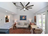 Cozy living room with vaulted ceilings, unique fan, and ample natural light from the large window at 452 S Main St # F, Davidson, NC 28036