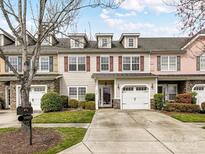 Charming townhouse with a well-maintained lawn, attached garage, and colorful window shutters at 4708 Chantress Ln, Monroe, NC 28110