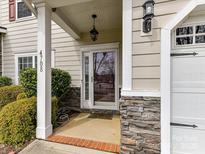 Inviting front entry featuring stone accents, classic columns, and a stylish pendant light at 4708 Chantress Ln, Monroe, NC 28110