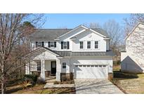 Charming two-story home with a well-manicured lawn and a two-car garage at 576 Putting Dr, Fort Mill, SC 29715