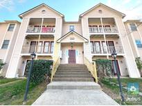 Inviting multi-story condo building with charming balconies and well-maintained landscaping at 6132 Meadow Rose Ln, Charlotte, NC 28215