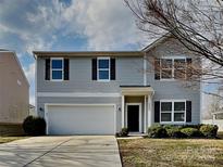 Charming two-story home with a well-maintained lawn and an attached two-car garage at 8906 Paddle Oak Rd, Charlotte, NC 28227