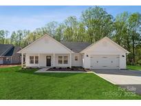 Charming single-story home featuring a well-manicured lawn, attached garage, and inviting covered porch at 902 Westminster Dr, Statesville, NC 28677