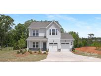 Charming two-story home with a two-car garage and beautifully landscaped front yard at 11032 Gary Player Dr # 961, Lancaster, SC 29720