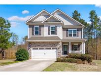 Charming two-story home featuring stone accents, neutral siding, and a well-manicured front yard at 111 Bell Chase Ln, Statesville, NC 28677