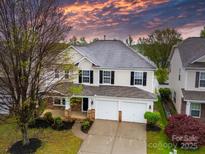 Charming two-story home with a manicured lawn, two-car garage, and inviting front porch at 118 Glade Valley Ave, Mooresville, NC 28117