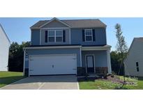 Charming two-story home with blue siding, a two-car garage, and a well-manicured front lawn at 1588 Doran Ter, Richburg, SC 29729
