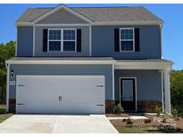 Charming two-story home featuring blue siding, black shutters, and a spacious two-car garage at 1588 Doran Ter, Richburg, SC 29729