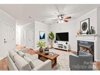 Bright living room boasts a cozy fireplace, modern furnishings, and stylish decor, creating a welcoming ambiance at 16911 Commons Creek Dr, Charlotte, NC 28277