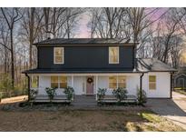Charming two-story home with a covered front porch and white and gray siding at 412 Montana Dr, Gastonia, NC 28056