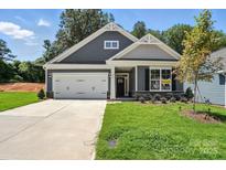 Charming single-story home featuring a two-car garage and landscaped front yard with available sign at 149 Prestwick Way # 39, Mooresville, NC 28115