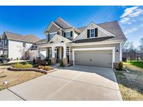 Beautiful two story home featuring a spacious driveway and manicured lawn on a clear day at 3193 Burnello Ct, Iron Station, NC 28080