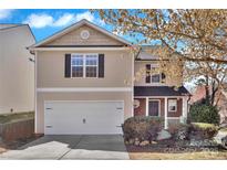 Charming two-story home with a manicured lawn and an attached two-car garage at 4635 Christenbury Hills Ln, Charlotte, NC 28269