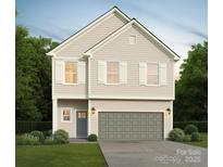 Charming two-story home with a gray garage door, complemented by white shutters and a well-manicured lawn at 5123 Izzo Ln, Charlotte, NC 28214