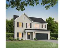 Two-story home featuring a two-car garage, neutral siding, black shutters, and a well-maintained lawn at 5127 Izzo Ln, Charlotte, NC 28214