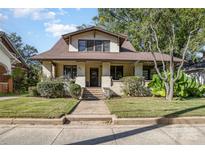 Charming two-story home with a landscaped front yard and inviting walkway to the front door at 642 W Front St, Statesville, NC 28677