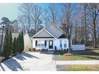 Charming single-story home with a well-manicured front yard and inviting front porch at 8421 Kings Creek Dr, Charlotte, NC 28273