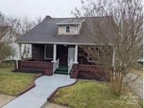 Charming single Gathering home with a brick foundation, covered porch, and well-maintained landscaping at 927 Locke St, Salisbury, NC 28144