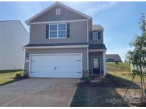 Two-story home featuring a clean two-car garage, neutral siding, and well-kept landscaping at 108 Lightning Dr, Shelby, NC 28152