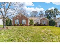 Charming single-story brick home with manicured lawn and inviting curb appeal at 10829 Carmody Ct, Charlotte, NC 28277