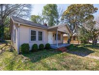 Charming single-story home featuring a cozy front porch and mature landscaping in a desirable neighborhood at 112 E Elliott St, Fort Mill, SC 29715