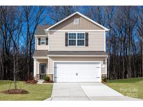 Charming two-story home with a two car garage and neutral beige siding at 119 Lightning Dr, Shelby, NC 28152