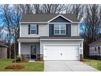 Charming two-story home featuring a two-car garage, covered porch, and neutral siding with blue accent at 125 Lightning Dr, Shelby, NC 28152