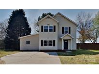 Charming two-story home with a well-maintained lawn and a long driveway provides ample parking space at 13903 Glendevon Ct, Charlotte, NC 28273