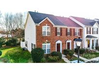 Charming two-story brick townhome with well-maintained landscaping and inviting front entrance at 1965 Charlotte Hwy # 401, Mooresville, NC 28115
