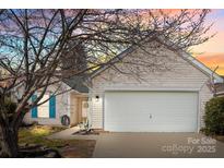 Charming home featuring a two-car garage, neutral siding, manicured lawn and inviting front entrance at 228 Grayland Rd, Mooresville, NC 28115