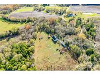 Expansive aerial view of a rural property with fields, trees, and charming country home at 2331 Gill Jordan Rd, Chester, SC 29706
