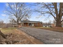 Charming brick ranch home with a covered parking area and a long driveway at 2500 Belshire Dr, Conover, NC 28613