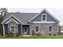 Charming single-story home with stone and siding accents, complemented by a well-manicured lawn at 506 Muirfield Way, Salisbury, NC 28144